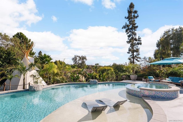 view of swimming pool with a patio and an in ground hot tub