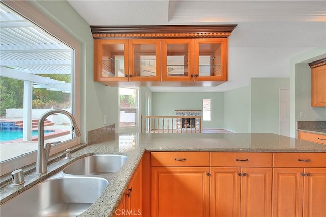 kitchen with a healthy amount of sunlight, sink, and kitchen peninsula