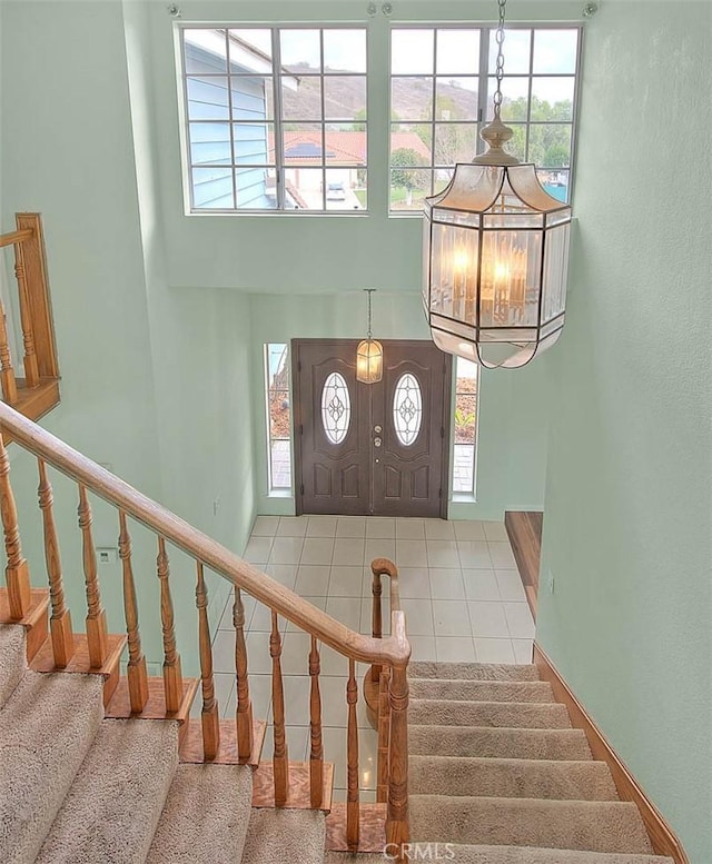 foyer entrance with a towering ceiling and plenty of natural light