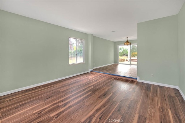 empty room with dark hardwood / wood-style floors