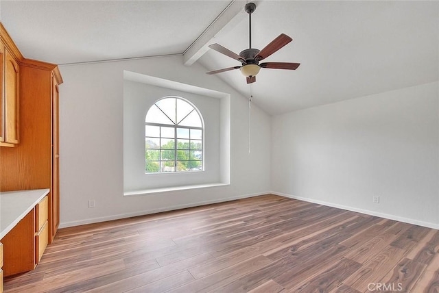 interior space with wood-type flooring, lofted ceiling with beams, and ceiling fan