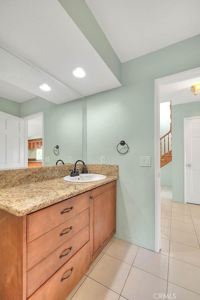 bathroom featuring tile patterned flooring and vanity