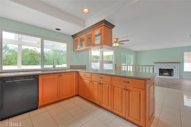 kitchen featuring sink, plenty of natural light, kitchen peninsula, and black dishwasher