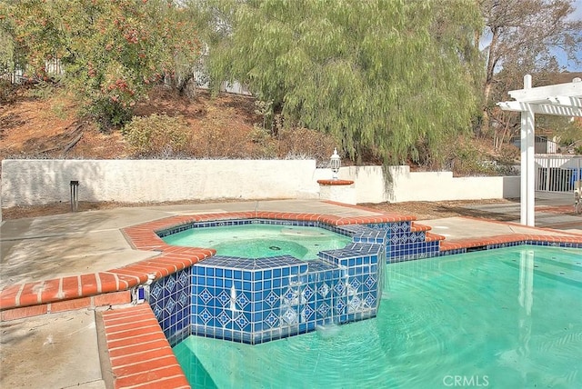 view of pool featuring an in ground hot tub and a pergola