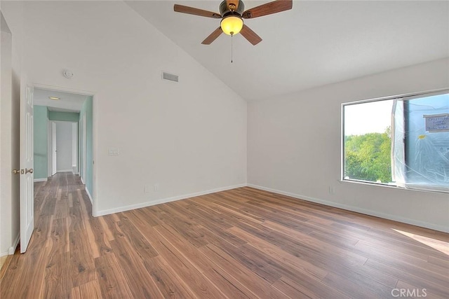 spare room with hardwood / wood-style flooring, ceiling fan, and high vaulted ceiling