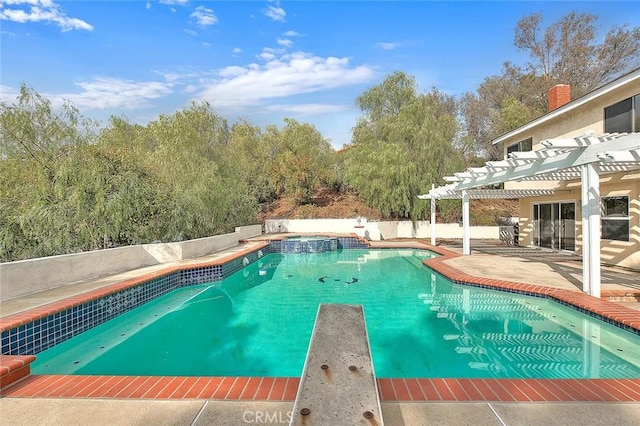 view of pool with a pergola, a patio area, and a diving board