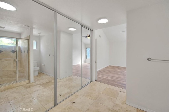 bathroom featuring tile patterned flooring, a healthy amount of sunlight, ceiling fan, and toilet