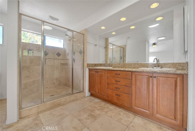 bathroom featuring tile patterned flooring, vanity, and a shower with shower door