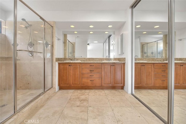 bathroom with tile patterned floors, vanity, and a shower with door