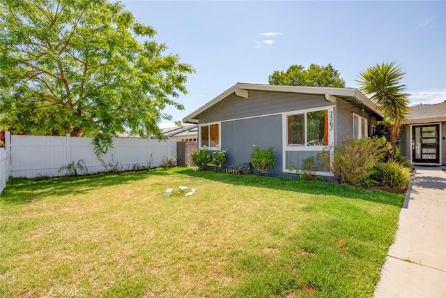 view of side of property featuring a lawn