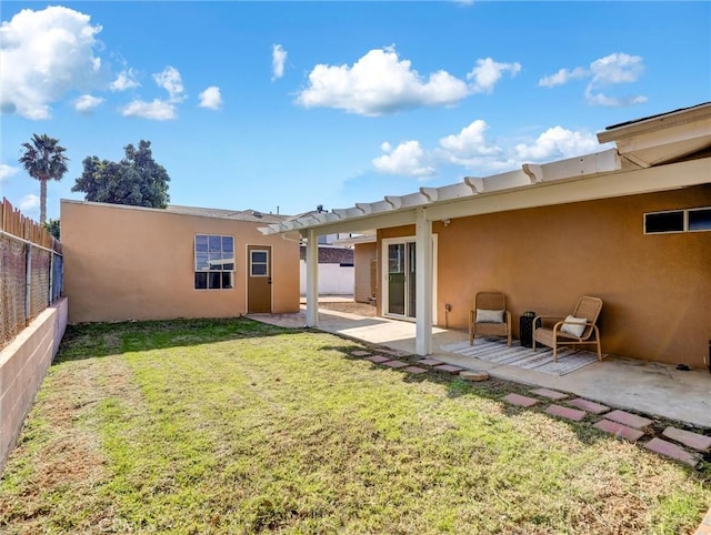 back of property with a patio and a yard