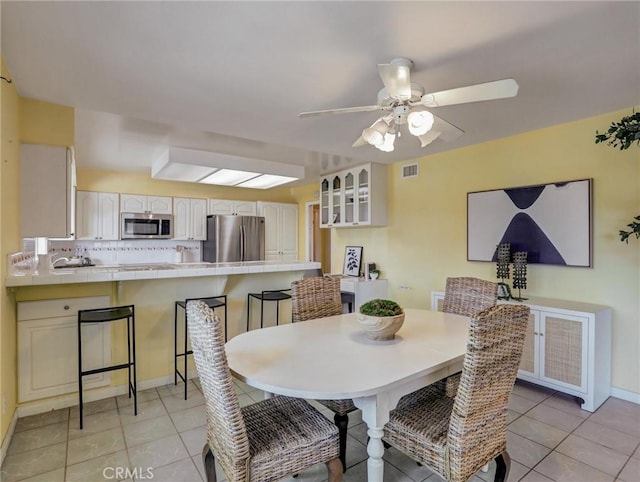 dining room featuring ceiling fan and light tile patterned floors