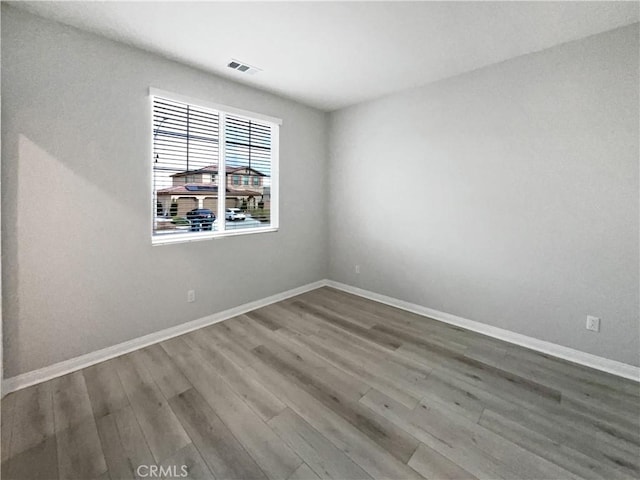 unfurnished room with wood-type flooring