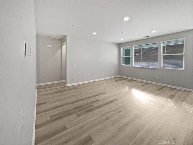 spare room with light hardwood / wood-style flooring