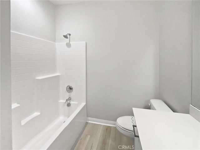 full bathroom featuring vanity, wood-type flooring, bathing tub / shower combination, and toilet