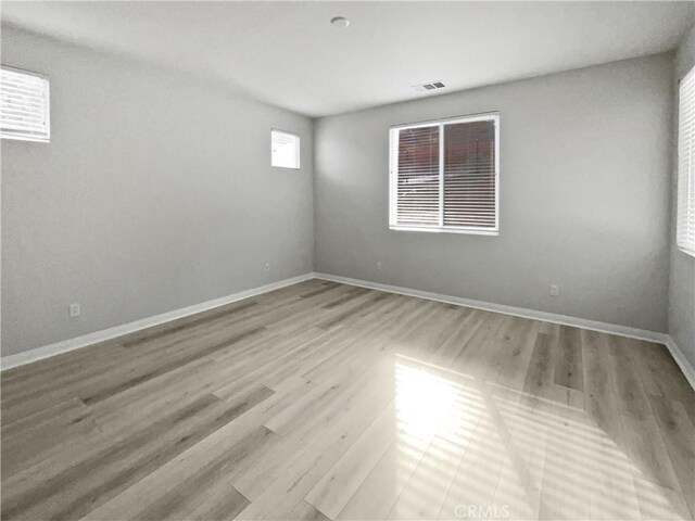 spare room with light hardwood / wood-style floors