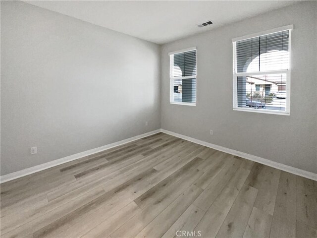 spare room with light hardwood / wood-style flooring