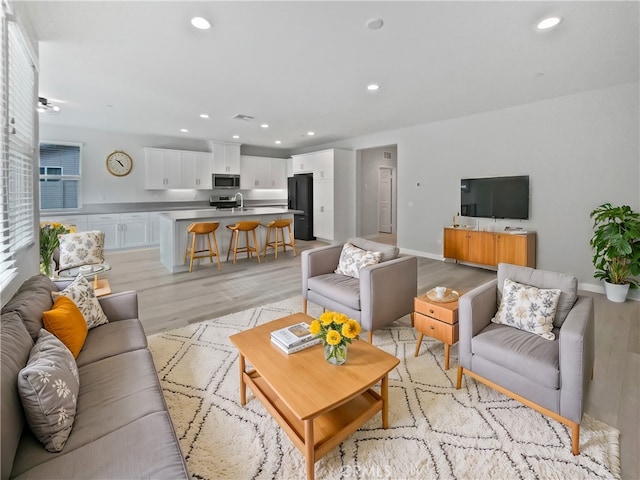 living room with light hardwood / wood-style flooring