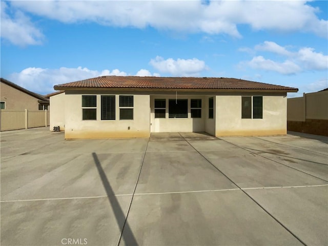 5393 Viewstone Ct, Hemet, CA 92545 - rear view of house featuring stucco siding, fence, a tiled roof, and a patio