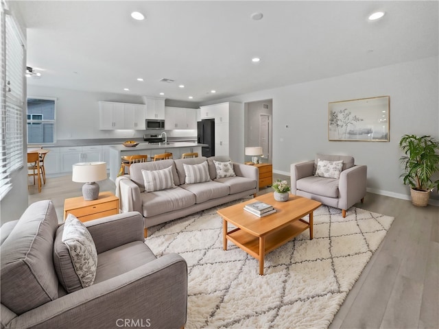 5393 Viewstone Ct, Hemet, CA 92545 - living area featuring light wood finished floors, recessed lighting, and baseboards