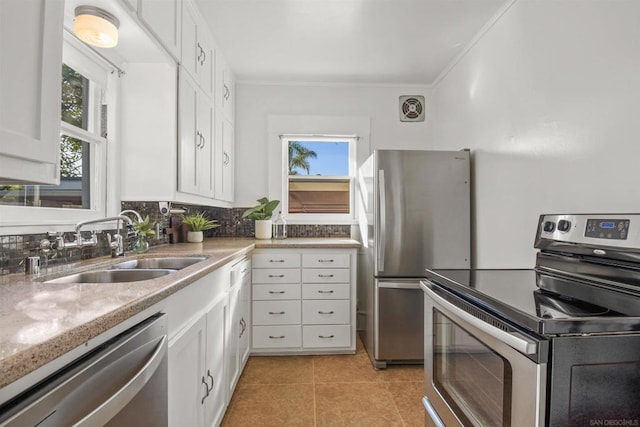 kitchen featuring white cabinetry, sink, a healthy amount of sunlight, and appliances with stainless steel finishes