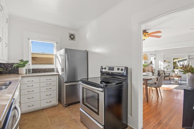 kitchen featuring white cabinetry, stainless steel appliances, sink, and plenty of natural light