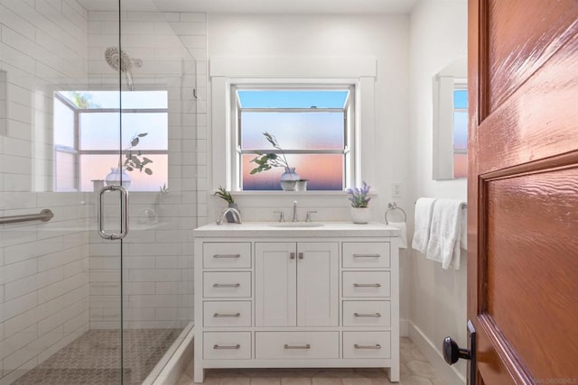 bathroom featuring an enclosed shower and vanity