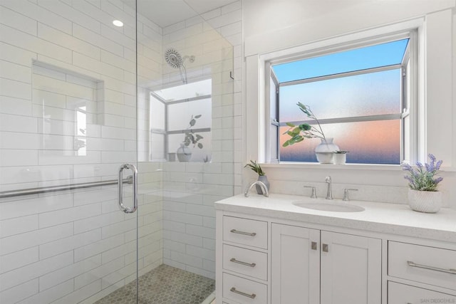 bathroom with sink and a shower with door