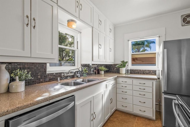 kitchen featuring white cabinetry, appliances with stainless steel finishes, sink, and backsplash