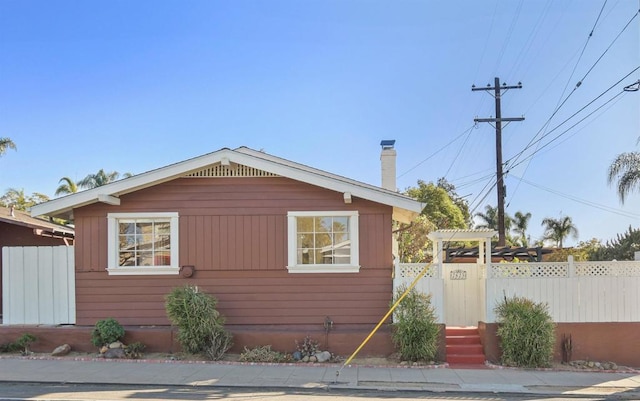 view of side of home featuring a pergola