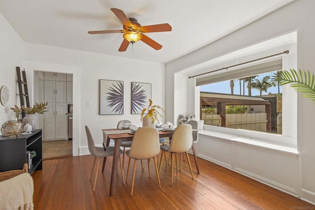 dining space with ceiling fan and hardwood / wood-style floors