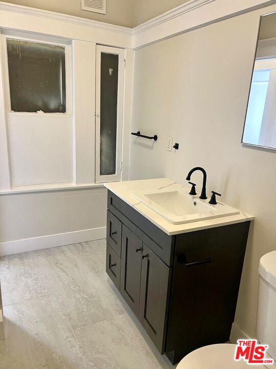 bathroom with vanity and toilet