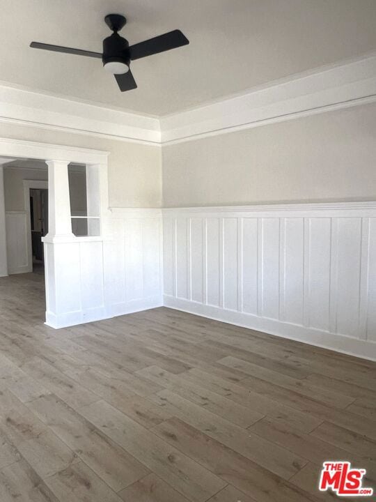 empty room with wood-type flooring and ceiling fan