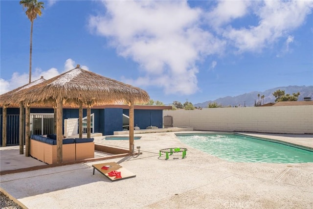 view of pool featuring a gazebo, a mountain view, and a patio area