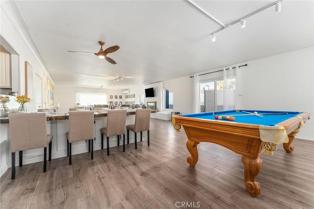 game room with a wealth of natural light, light hardwood / wood-style flooring, ceiling fan, and track lighting