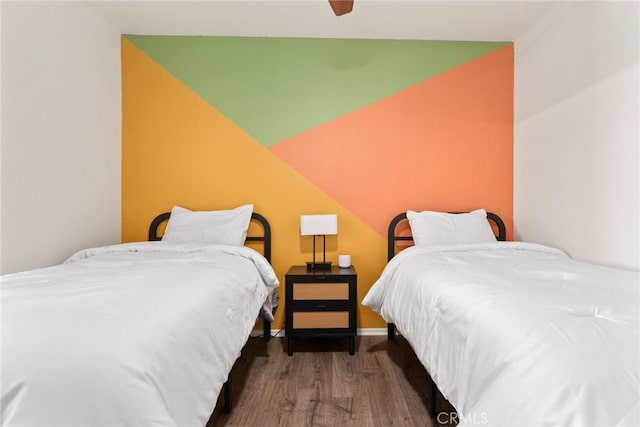 bedroom featuring ceiling fan and dark hardwood / wood-style flooring