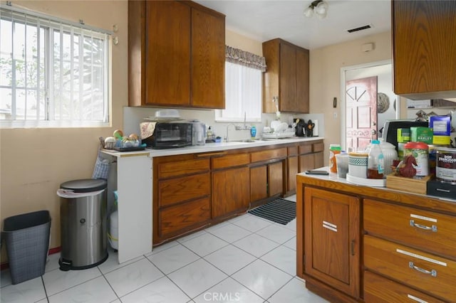 kitchen featuring light tile patterned flooring and sink