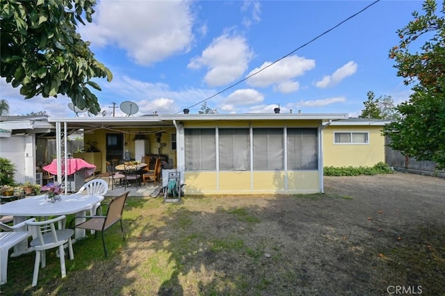 back of house with a patio and a sunroom