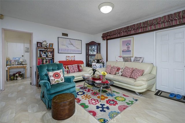 living room with parquet flooring and a textured ceiling