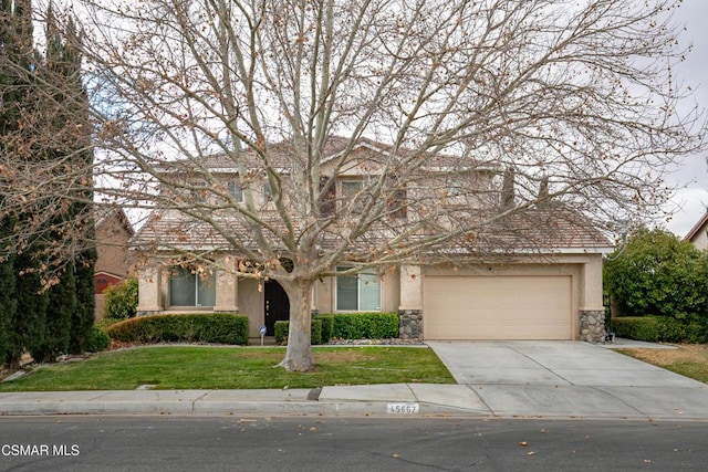 view of front of home with a garage and a front yard