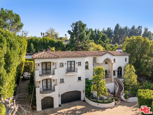 mediterranean / spanish house featuring a balcony and a garage