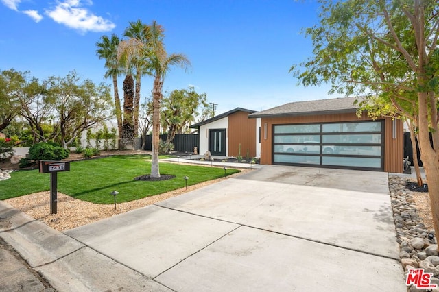 view of front of home featuring a garage and a front yard