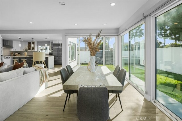 dining area with a wealth of natural light and light hardwood / wood-style floors