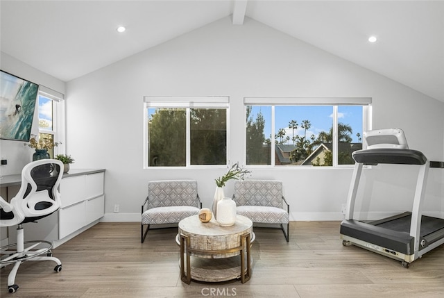 interior space with lofted ceiling and light hardwood / wood-style flooring