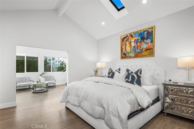 bedroom with beamed ceiling, a skylight, high vaulted ceiling, and hardwood / wood-style flooring