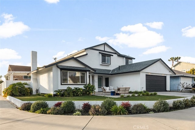 view of front of home featuring a garage and a front yard