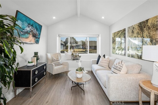 living room featuring beamed ceiling, wood-type flooring, and high vaulted ceiling