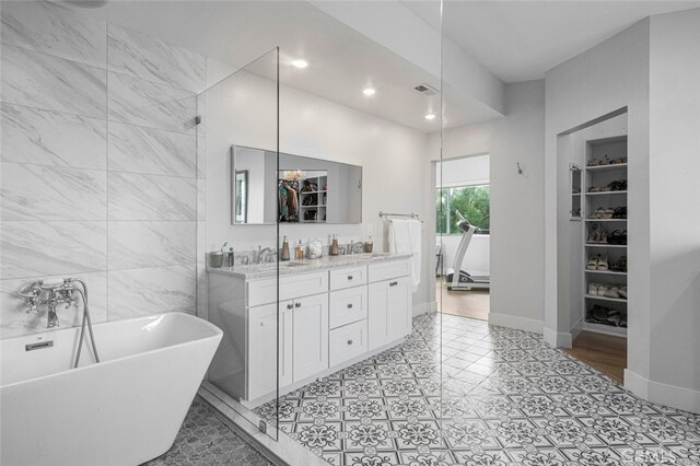 bathroom with vanity and a tub