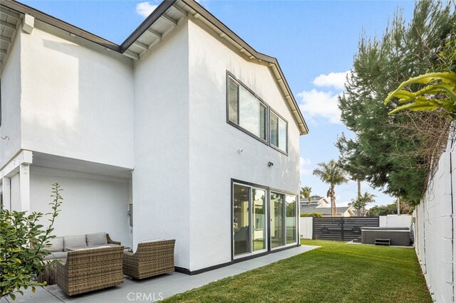 rear view of house with an outdoor living space and a yard