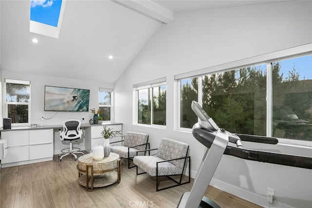 sitting room featuring beam ceiling, high vaulted ceiling, light hardwood / wood-style floors, and a skylight